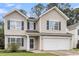 Two-story home with large front windows and a two-car garage, framed by a manicured lawn at 125 Towering Pine Dr, Ladson, SC 29456