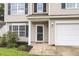 Close up of a two-story home, front door entrance with a well-manicured lawn at 125 Towering Pine Dr, Ladson, SC 29456