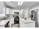 Bright kitchen features white cabinets, stainless steel appliances, and a functional center island at 125 Towering Pine Dr, Ladson, SC 29456