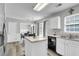 Bright kitchen features white cabinets, stainless steel appliances, and a functional center island at 125 Towering Pine Dr, Ladson, SC 29456