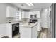 Bright kitchen features white cabinets, stainless steel appliances, and a functional center island at 125 Towering Pine Dr, Ladson, SC 29456