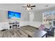 Relaxing living room with fireplace, large TV, wainscoting and natural light at 125 Towering Pine Dr, Ladson, SC 29456