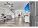 Bright, open living room with hardwood floors, modern furnishings, and large-screen TV at 125 Towering Pine Dr, Ladson, SC 29456