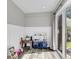 Charming playroom with a toy kitchen set, wood-look flooring, and sliding glass door to backyard at 125 Towering Pine Dr, Ladson, SC 29456