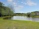 Scenic view of a tranquil pond surrounded by lush greenery, offering a serene and picturesque setting at 125 Towering Pine Dr, Ladson, SC 29456