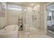 Elegant bathroom featuring a soaking tub and glass-enclosed shower with neutral color palette at 128 Sandy Bend Ln, Summerville, SC 29486