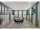 Stylish dining room with blue accent wall, a decorative chandelier, and green drapes at 128 Sandy Bend Ln, Summerville, SC 29486