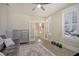 Bright living room with couch, dresser, weights, and a ceiling fan creates a comfortable and functional space at 128 Sandy Bend Ln, Summerville, SC 29486