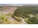 Aerial view of the property with mature trees and two structures near a lake at 1298 French Santee Rd, Jamestown, SC 29453