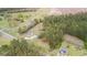 Expansive aerial view showcases the property's landscape with mature trees and two structures at 1298 French Santee Rd, Jamestown, SC 29453