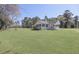 Quaint two-story home with a welcoming front porch surrounded by a lush green lawn at 1298 French Santee Rd, Jamestown, SC 29453