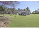 Charming home with a large lawn and a utility shed, surrounded by trees at 1298 French Santee Rd, Jamestown, SC 29453