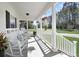 Inviting front porch with rocking chairs and hanging plants, perfect for relaxing and enjoying the outdoors at 1298 French Santee Rd, Jamestown, SC 29453