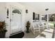 Charming front porch featuring classic rocking chairs and a welcoming entrance with decorative plants at 1298 French Santee Rd, Jamestown, SC 29453
