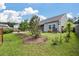 Landscaped backyard with fresh sod, new trees, and a cozy outdoor patio on a beautiful day at 143 Daniels Creek Cir, Goose Creek, SC 29445