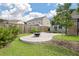 Backyard with gravel area featuring a fire pit, beautiful trees, and a wooden fence for privacy at 143 Daniels Creek Cir, Goose Creek, SC 29445
