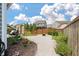 Well-manicured backyard featuring a gravel patio, plantings, lounging area, and a privacy fence at 143 Daniels Creek Cir, Goose Creek, SC 29445