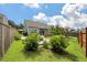 Well-maintained backyard featuring a manicured lawn, patio, shrubs, and privacy fence at 143 Daniels Creek Cir, Goose Creek, SC 29445