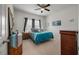 Comfortable bedroom with an turquoise comforter, dresser, ceiling fan, and plenty of natural light at 143 Daniels Creek Cir, Goose Creek, SC 29445