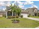 Inviting brick home with a well-maintained lawn, a two-car garage, and shuttered windows at 143 Daniels Creek Cir, Goose Creek, SC 29445