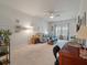 Bright living room featuring neutral carpet, ceiling fan, and plenty of natural light from the window at 143 Daniels Creek Cir, Goose Creek, SC 29445