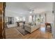 Bright and airy living room with hardwood flooring, neutral decor, and abundant natural light at 143 Daniels Creek Cir, Goose Creek, SC 29445