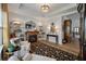 Bright living room with fireplace, stylish furniture, and adjacent hallway at 143 Daniels Creek Cir, Goose Creek, SC 29445