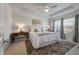Bright main bedroom suite featuring a tray ceiling, large windows, and a luxurious, comfortable bed at 143 Daniels Creek Cir, Goose Creek, SC 29445