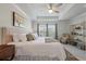 Bright main bedroom suite featuring a tray ceiling, large windows, and a luxurious, comfortable bed at 143 Daniels Creek Cir, Goose Creek, SC 29445