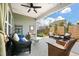 Inviting outdoor patio with stylish wicker furniture, ceiling fan, and a comfortable seating area at 143 Daniels Creek Cir, Goose Creek, SC 29445