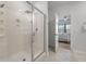 Modern walk-in shower featuring glass enclosure, rainfall shower head, and an open view to the main bedroom at 143 Daniels Creek Cir, Goose Creek, SC 29445