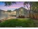Beautiful backyard with green grass, fire pit, outdoor seating and dining area at 1430 E Montague Ave, North Charleston, SC 29405