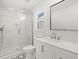 Clean bathroom with marble shower, glass door, sleek fixtures, and black-and-white patterned floor at 1430 E Montague Ave, North Charleston, SC 29405