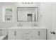 Bright bathroom featuring double vanity, marble countertop, sleek fixtures, and a modern mirror at 1430 E Montague Ave, North Charleston, SC 29405
