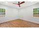 Spacious bedroom featuring hardwood floors, two windows, and a ceiling fan at 1430 E Montague Ave, North Charleston, SC 29405