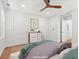 Spacious bedroom featuring hardwood floors, a ceiling fan, and two closets at 1430 E Montague Ave, North Charleston, SC 29405
