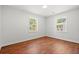 Well-lit bedroom with hardwood flooring, lots of natural light, and space for customization at 1430 E Montague Ave, North Charleston, SC 29405
