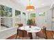 Bright breakfast nook with outdoor access and featuring a round table and many windows at 1430 E Montague Ave, North Charleston, SC 29405