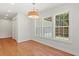 Bright breakfast nook featuring hardwood floors, many windows, and white trim at 1430 E Montague Ave, North Charleston, SC 29405