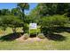 Palmetto Gardens community sign nestled among lush landscaping and mature trees for a serene welcome at 1430 E Montague Ave, North Charleston, SC 29405
