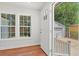 Bright entryway with hardwood flooring, large windows, and a view of the detached garage at 1430 E Montague Ave, North Charleston, SC 29405
