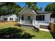 Beautifully designed home with a welcoming front porch, landscaped yard, and a well-manicured lawn at 1430 E Montague Ave, North Charleston, SC 29405