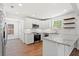 Modern kitchen with white cabinets, granite countertops, stainless steel appliances, and hardwood floors at 1430 E Montague Ave, North Charleston, SC 29405
