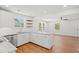 Bright kitchen features white cabinets, floating shelves, granite countertops, and stainless steel appliances at 1430 E Montague Ave, North Charleston, SC 29405