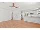 Spacious open floor plan with hardwood floors connecting living area and kitchen with stainless steel appliances at 1430 E Montague Ave, North Charleston, SC 29405