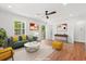 Bright living room featuring hardwood floors, a ceiling fan, and neutral decor; great natural lighting at 1430 E Montague Ave, North Charleston, SC 29405
