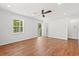 Bright living room featuring hardwood floors, a ceiling fan, and an inviting door to the front porch at 1430 E Montague Ave, North Charleston, SC 29405