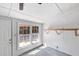 Enclosed back porch featuring an exterior door, window, ceiling fan and white walls at 1593 Westwood Dr, Charleston, SC 29412