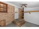 Enclosed back porch featuring brick walls, an exterior door, ceiling fan and overhead storage at 1593 Westwood Dr, Charleston, SC 29412