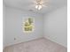 Bright bedroom with neutral colored carpet and a window looking out into the exterior of the home at 1593 Westwood Dr, Charleston, SC 29412